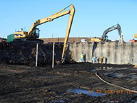 December 2013 - Workers clean the sheet pile